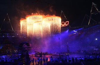 Artists perform as the Olympic rings are seen over the stadium during the Opening Ceremony of the London 2012 Olympic Games, London, Britain, 27 July 2012. The 2012 Summer Olympic Games will be held i...