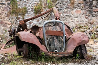 Rusting car at Oradour-sur-Glane. The village was destroyed on 10 June 1944 by German soldiers.