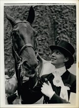Jun. 06, 1956 - Equestrian Olympic games in Stockholm. Danish rider wins silver medal in Dressage. Photo shows Lis Hartel (Denmark) with her silver medal and her mount ''Jubilee'' after they had won s...