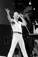Freddie Mercury, lead singer of British rock group Queen, performing on stage at Wembley Stadium during the Live Aid concert. 13th July 1985.