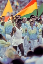 Rafer Johnson brings Olympic torch during opening ceremonies at 1984 Olympic Games in Los Angeles.