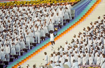 Rafer Johnson brings Olympic torch to light flame during opening ceremonies at 1984 Olympic Games in Los Angeles.