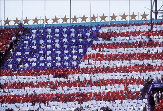 Card display in stadium during opening ceremonies at 1984 Olympic Games in Los Angeles.