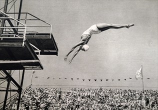 Photograph of Jane Fauntz (1910 - 1989) competing in the springboard diving event at the 1932 Olympic games. She took home the bronze medal for the USA in the event.
