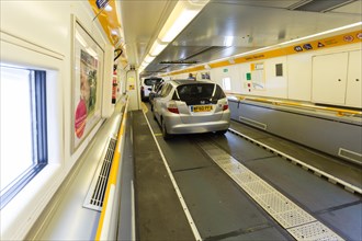 Vehicles parked on the Channel Tunnel, or Chunnel, Shuttle, train carrying them from England to France