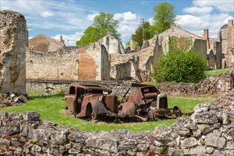 Oradour-sur-Glane, France - April 29, 2019: Old car wrecks in the ruins of the village after the massacre by the german nazi's in 1944 that destroyed