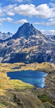 Vertical panoramic view at Midi Ossau mountain peak and Lake Gentau from the mountain pass Ayous in Franch Atlantic Pyrenees, as seen in October. Aqui
