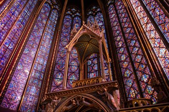 The Sainte-Chapelle church walls filled with colorful stained glass window panels in Paris, France, Europe