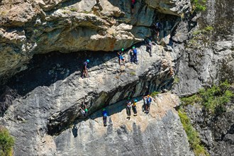 Crowds of people on Via Ferrata, The granite valley of Ailefroide, near, Briancon, in the Ecrins National Park, France