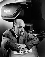 Film director Alfred Hitchcock with a VistaVision camera in a soundproof casing, circa 1954. File Reference # 34000-239THA