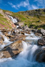 Alpine waterfall on the GR Tour du Mont-Blanc trail to the Robert Blanc refuge, Savoie (73), Auvergne-Rhone-Alpes, France