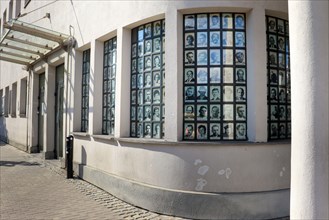 Windows with pictures at Oskar Schindler 's Enamel Factory, a former metal item factory in Krakow which has been turned into museums.