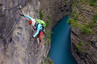 man on steep rock face, via ferrata du Barrage du Sautet, France, Isere