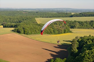 The Yonne department seen from the sky by paramotor over fields , Bourgogne région, France