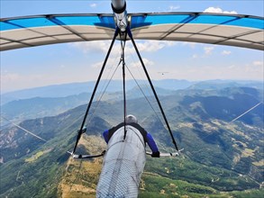 Hang glider pilots race on high altitude above mountain ridges. Extreme sports