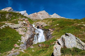 Alpine waterfall on the GR Tour du Mont-Blanc trail to the Robert Blanc refuge, Savoie (73), Auvergne-Rhone-Alpes, France