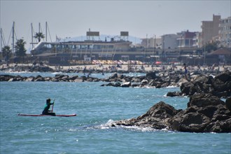 Woman on a paddle in Palavas les Flots, near Carnon Plage and Montpellier, Occitaine, south of France