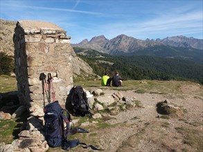 GR20 trekkers taking a rest at Col de St Pierre between Castel de Vergio and Lac de Nino, Corsica, France