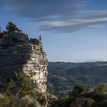 Men standing on top of a cliff