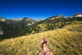 Landscape and legs during mountain hiking at Pyrenean mountain