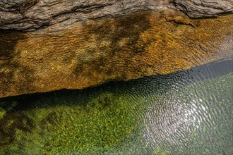 Top view of the water of a river and a rock bank. The wind gives the whole a superb texture. On the GR 70, Robert Louis Stevenson Trail, Cevennes, Fra