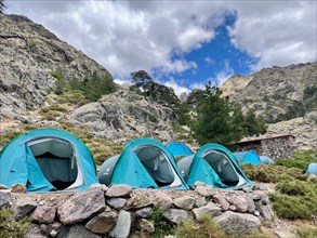 Biwak tents at Bergerie de Ballone, along the GR 20 trail. Outdoor camping in the mountains of Corsica, France.