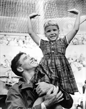 BURT LANCASTER with his daughter on set candid during filming TRAPEZE 1956 director CAROL REED Hecht-Lancaster Productions / Joanna Productions / Susan Productions / United Artists