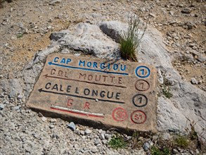 Marseille, France - May 20th 2022: A typical hiking sign on a rock in Calanques National Park.