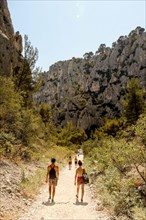 Hiking,down,to,Calanque D'En Vau,beach,from,top of cliffs above,difficult,hike,with, sandy,beach,tour boats,and,cliffs.Marseille,Calanques of Marseille,Calanques National Park,Marseilles,Commune in, B...