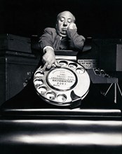 Alfred Hitchcock for "Dial M For Murder" by Sanford H. Roth (Warner Brothers, 1954).