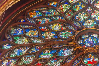 Paris, France - Dec. 27 2022: The stunning stained glass window and the beautiful ceiling in Saint-Chapelle in Paris