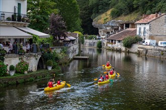 Messing about on the river! Canoists on the River Dronne in Brantome, Dordogne, France