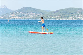 Stand-up paddling in the bay of Almanarre near Giens, southern France