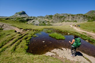 hikers on Lac du Miey, Ayous lakes tour, Pyrenees National Park, Pyrenees Atlantiques, France