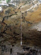 france pyrenees ariege grotte de mas d'asil cave with road through it bungee jumper