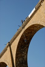 Stock photo a bungee jumper jumping off a viaduct in I'sle Jourdain France