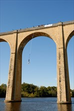 Stock photo a bungee jumper jumping off a viaduct in I'sle Jourdain France