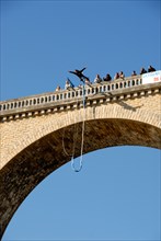 Stock photo a bungee jumper jumping off a viaduct in I'sle Jourdain France