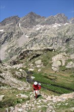Walker climbing above Valle de la Fous in the French Mercantour national Park, Alpes Maritimes