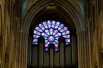 View of Church music organ and Stained Glass window from inside Notre Dame de Paris