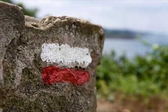 France, Brittany, Saint-Quay-Portrieux, Mark of the coastal trail Sentier des Douaniers GR34