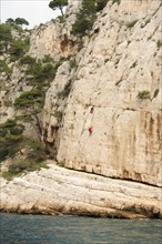 France Cote d'Azur Provence Cassis Les Calanques climbers climbing the shear rock cliffs Mediterranean Sea