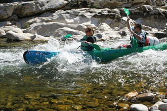 Canoeists in rapids on the River Ardeche, France.