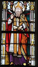 STABROEK, BELGIUM - JUNE 27, 2015: Stained glass window depicting Saint Ambrose or Ambrosius, in the Church of Stabroek, Belgium