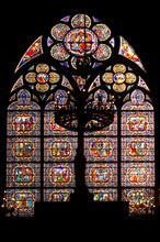 Stained glass window on southern facade of Notre Dame cathedral in Paris, France.