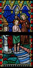 LIER, BELGIUM - MAY 16, 2015: Stained Glass window in St Gummarus Church in Lier, Belgium, depicting the Baptism of Christ by Sa