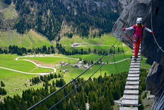 climber on simple suspension bridge, Via ferrata Yves Pollet-Villard, France, Haute Savoie, La Clusaz