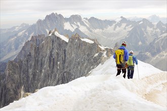 A group of mountain climbers descend from Aiguille du Midi near Chamonix, France.