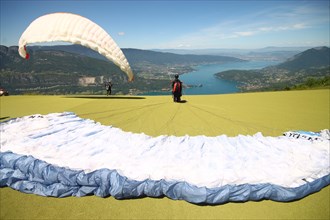 Paragliders launching above Lake Annecy France