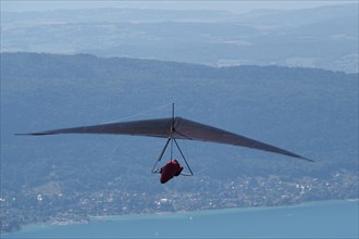 Hang glider flying above Lake Annecy France